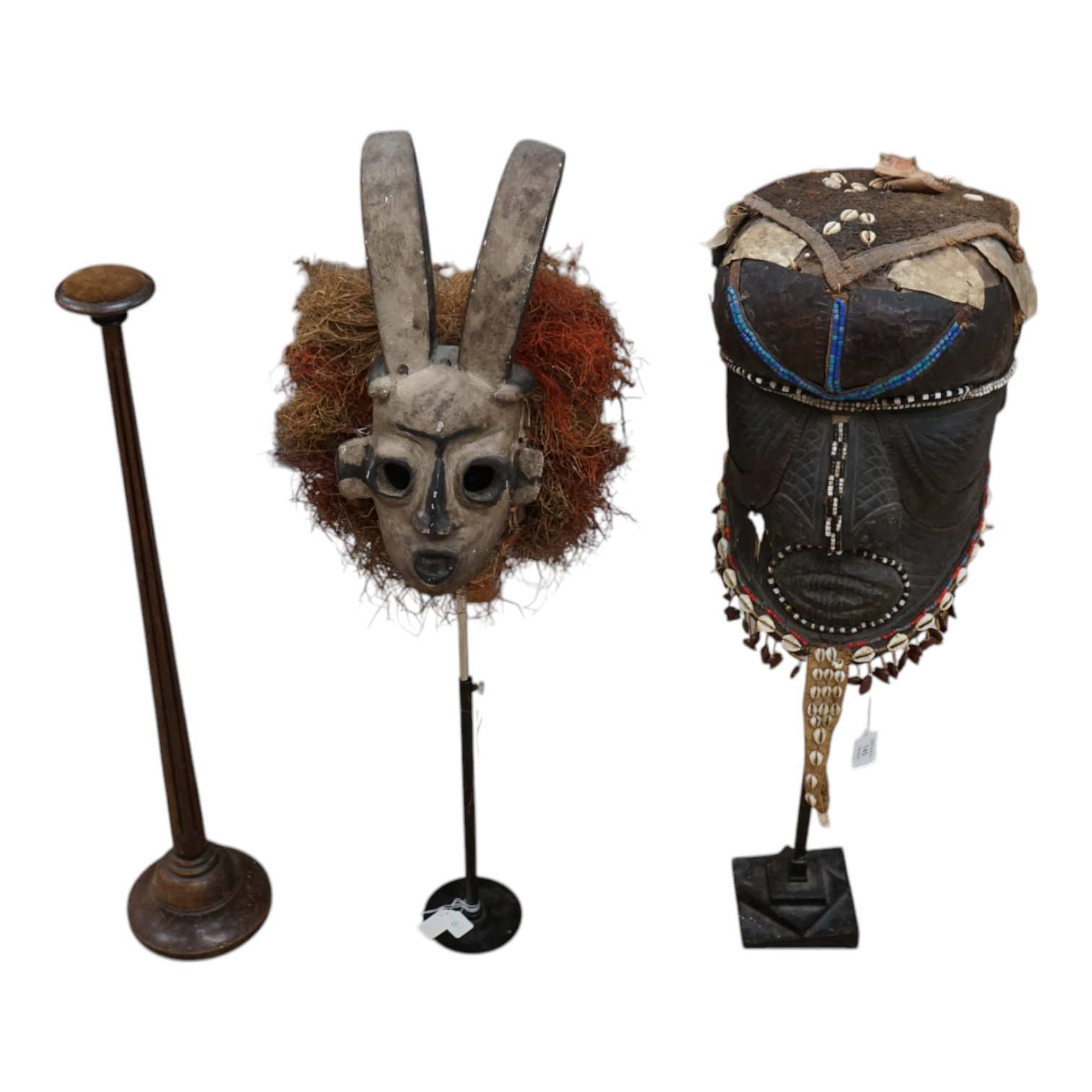 An African Kuba helmet mask and another horned mask, both on stands & one spare. Condition - helmet mask damaged